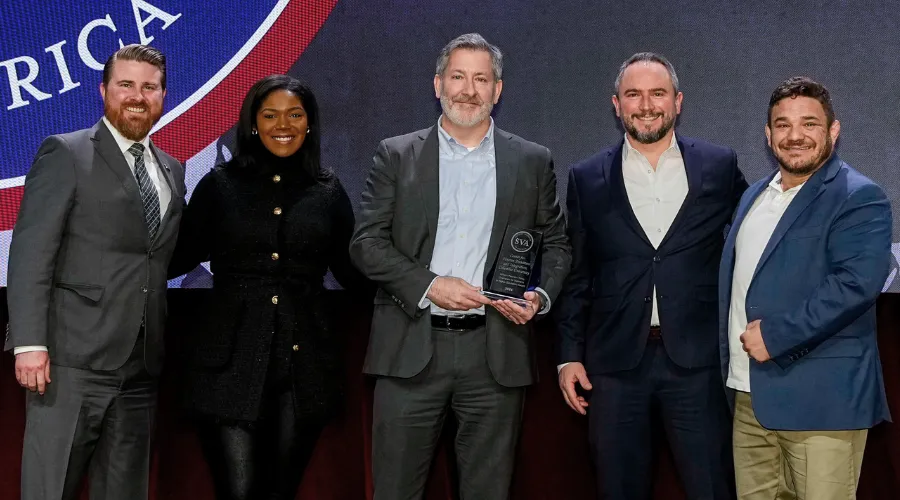 A group of representatives from Columbia University Center for Veteran Transition and Integration recieve an award from Student Veterans of America CEO Jared Lyon.
