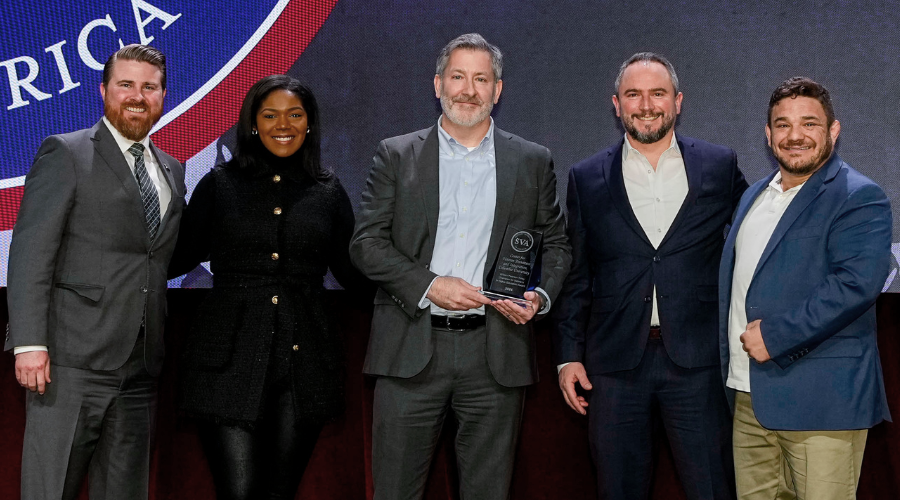 A group of representatives from Columbia University Center for Veteran Transition and Integration recieve an award from Student Veterans of America CEO Jared Lyon.